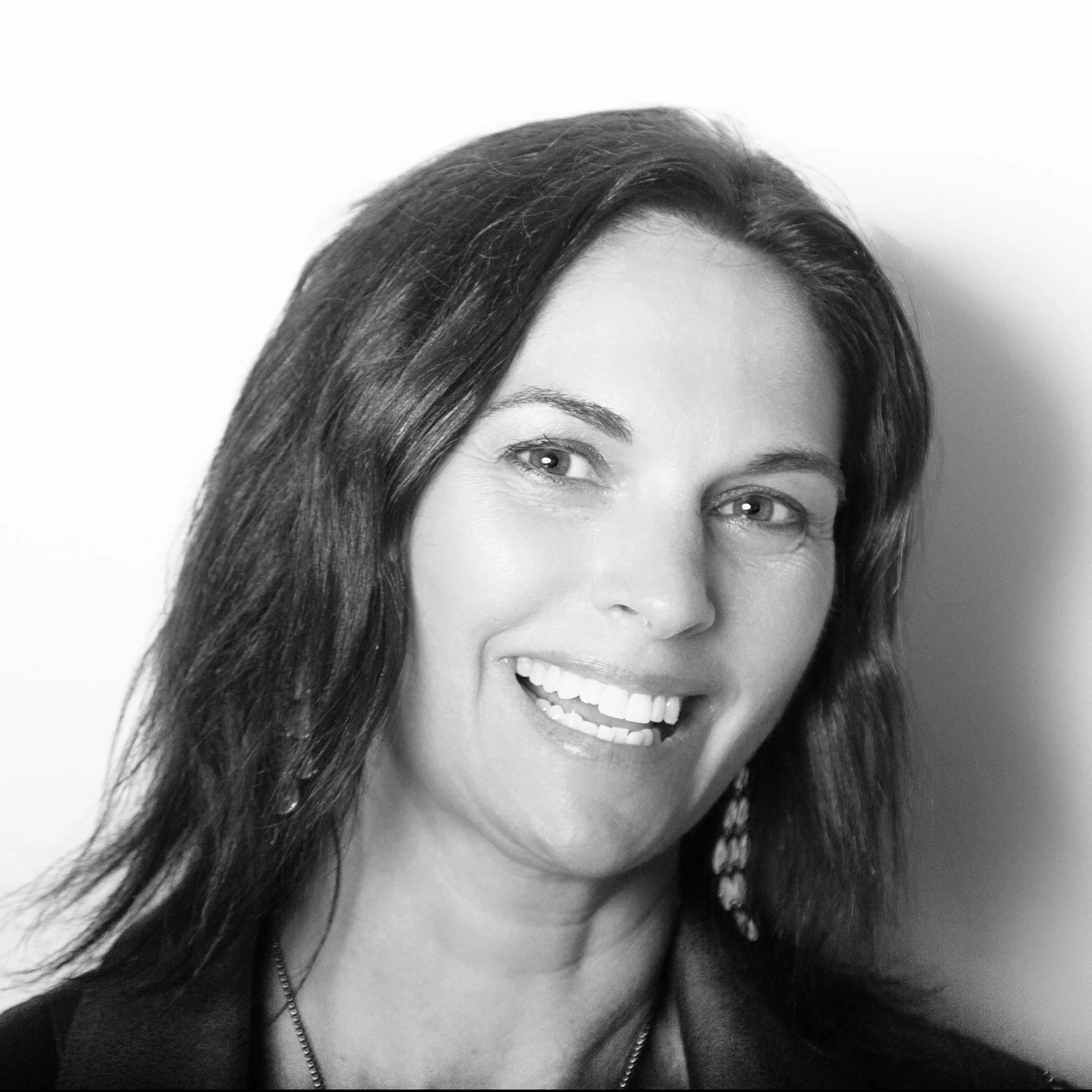 Smiling person in black and white portrait with short hair