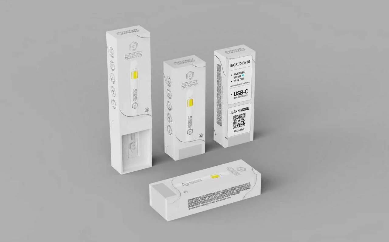 Four packages of resin refill cartridges for a device, three standing upright and one lying down, with the instruction to learn more via a QR code on the third package.