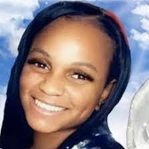 Mikeona Johnson smiling into the camera.