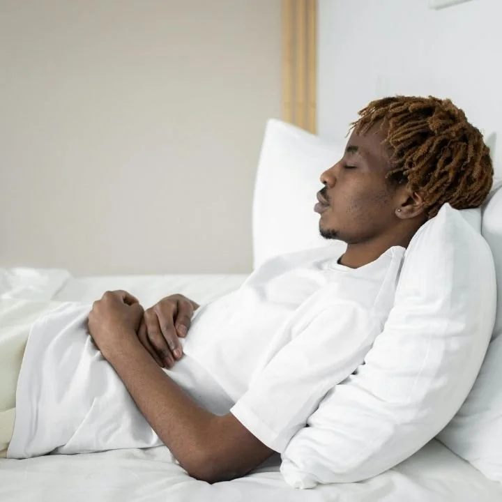 Patient resting in bed during shoulder surgery recovery period.