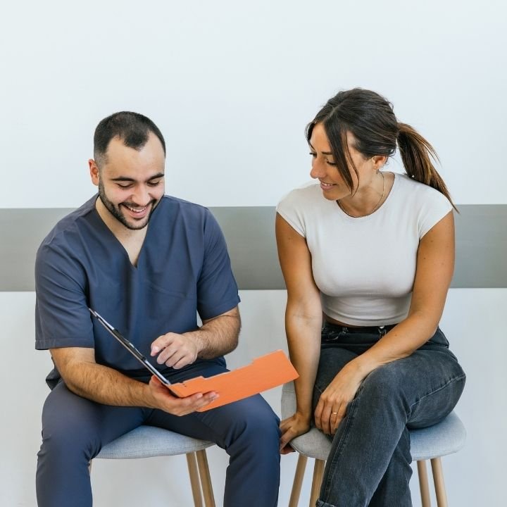 Physical therapist reviewing treatment information with a patient before starting care.