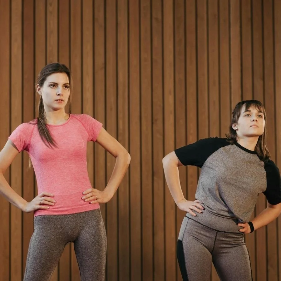 Athletes performing standing hip circles warm-up stretch.
