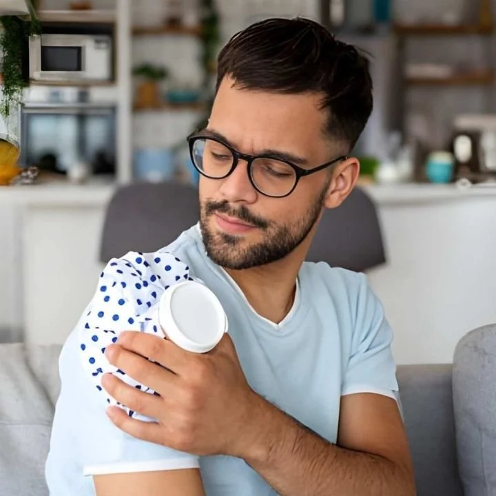 Man applying a cold pack to his shoulder after surgery.