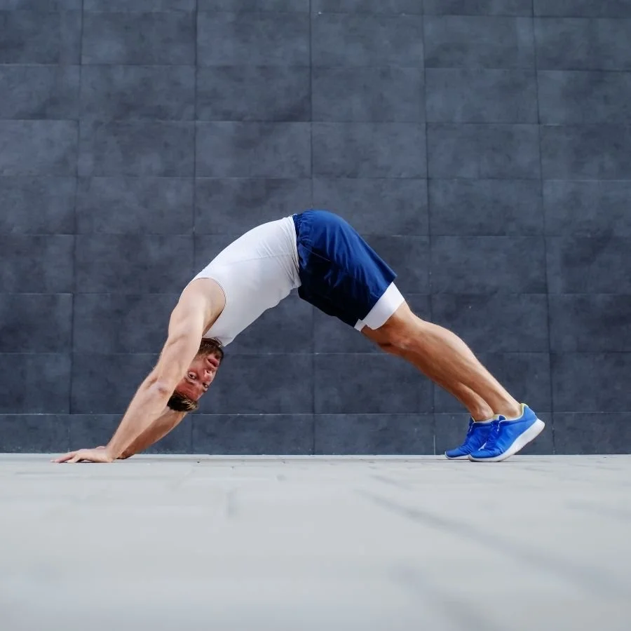 Athlete holding downward dog stretch for mobility and flexibility.