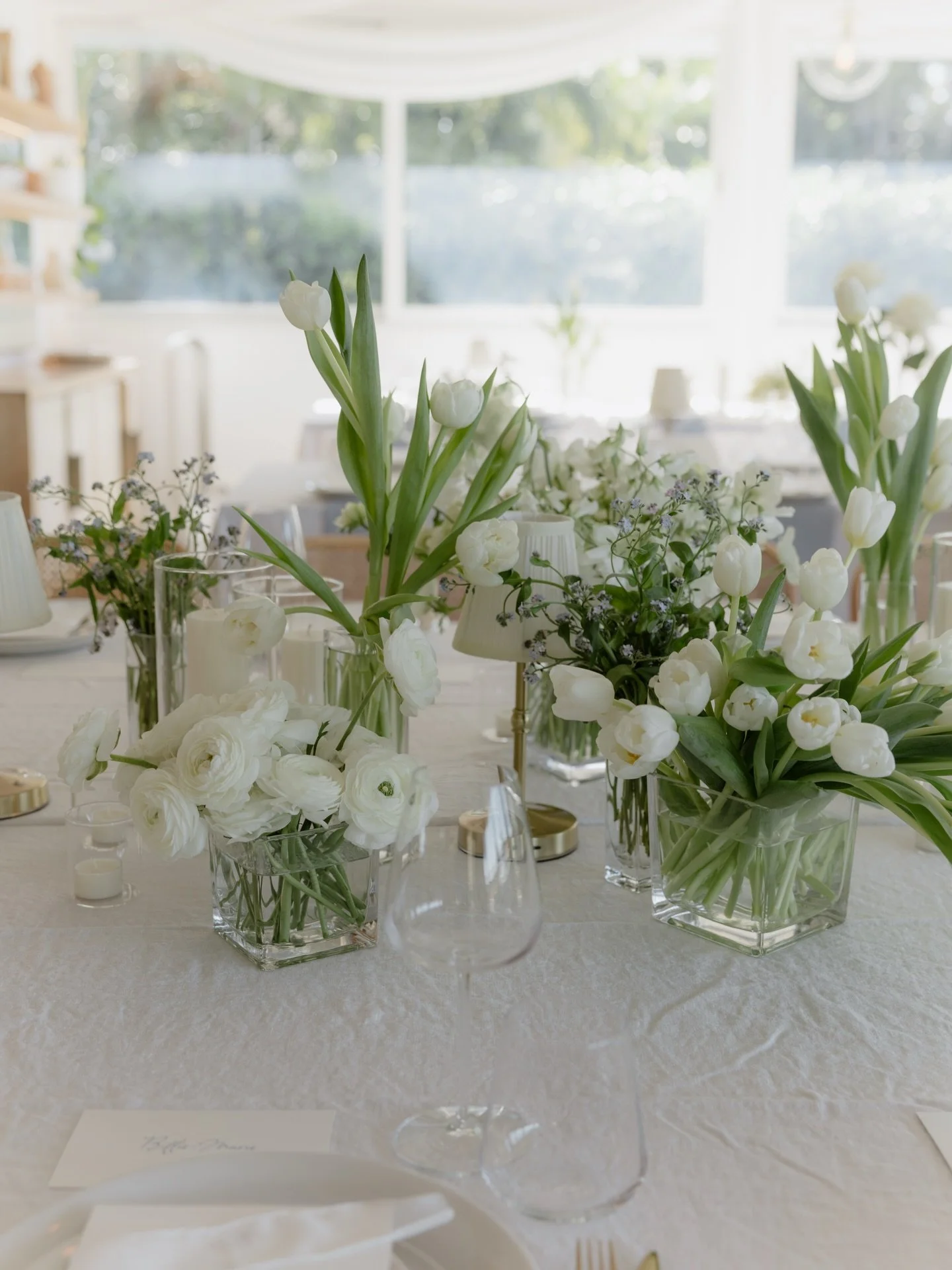 Reception table details for Danielle &amp; Riley captured beautifully by @biancavirtueweddings 🤍 
a mixture of petite arrangements with seasonal spring blooms &amp; stem vases filled with tulips + roses
