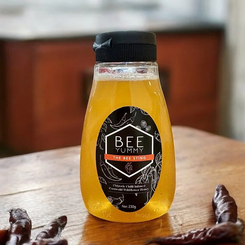 Bee Yummy Bee Sting Hot Honey bottle with dried chipotle chillies.