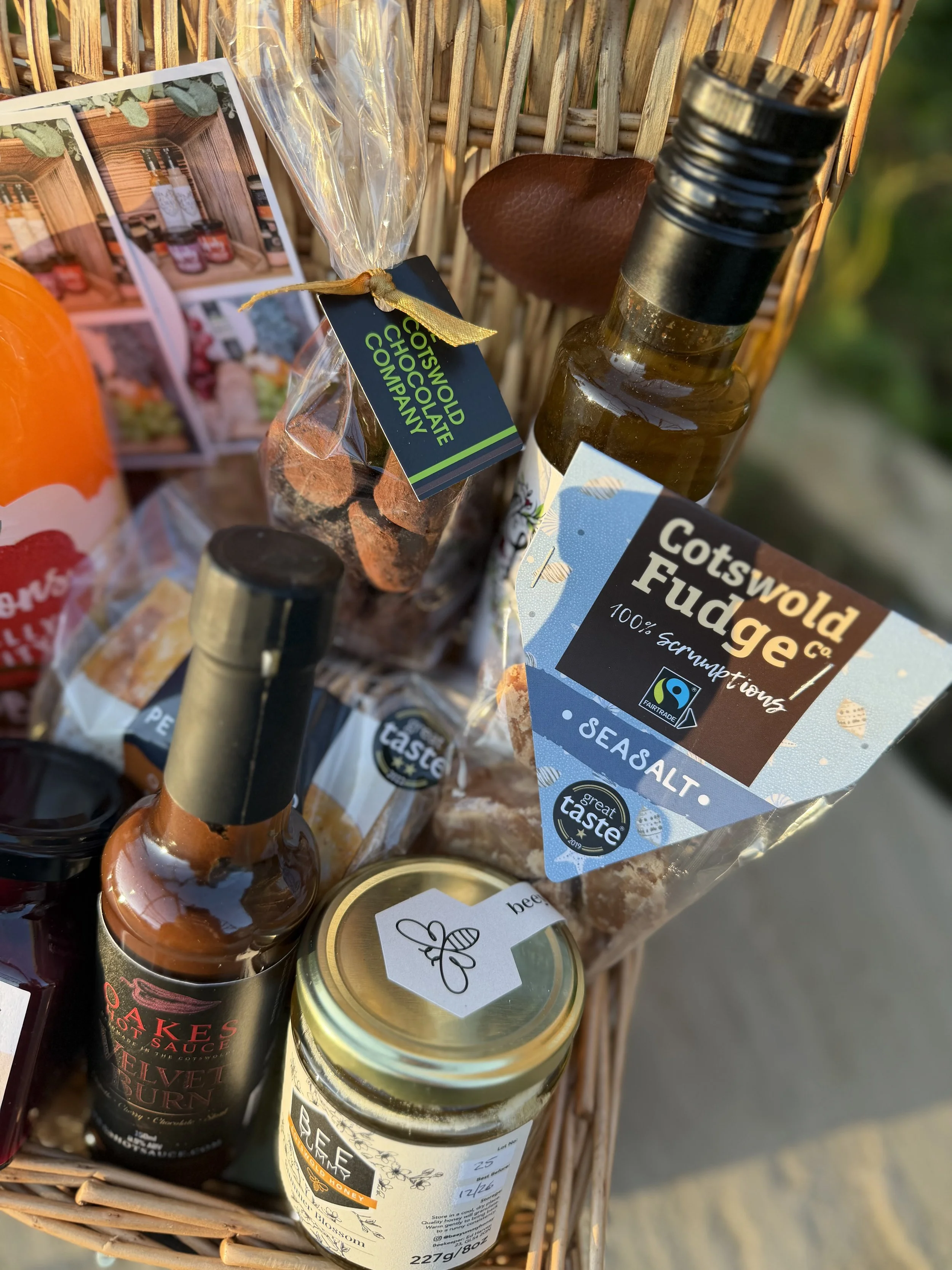 Close view of Cotswold hamper showing chutney, hot sauce, honey and fudge.