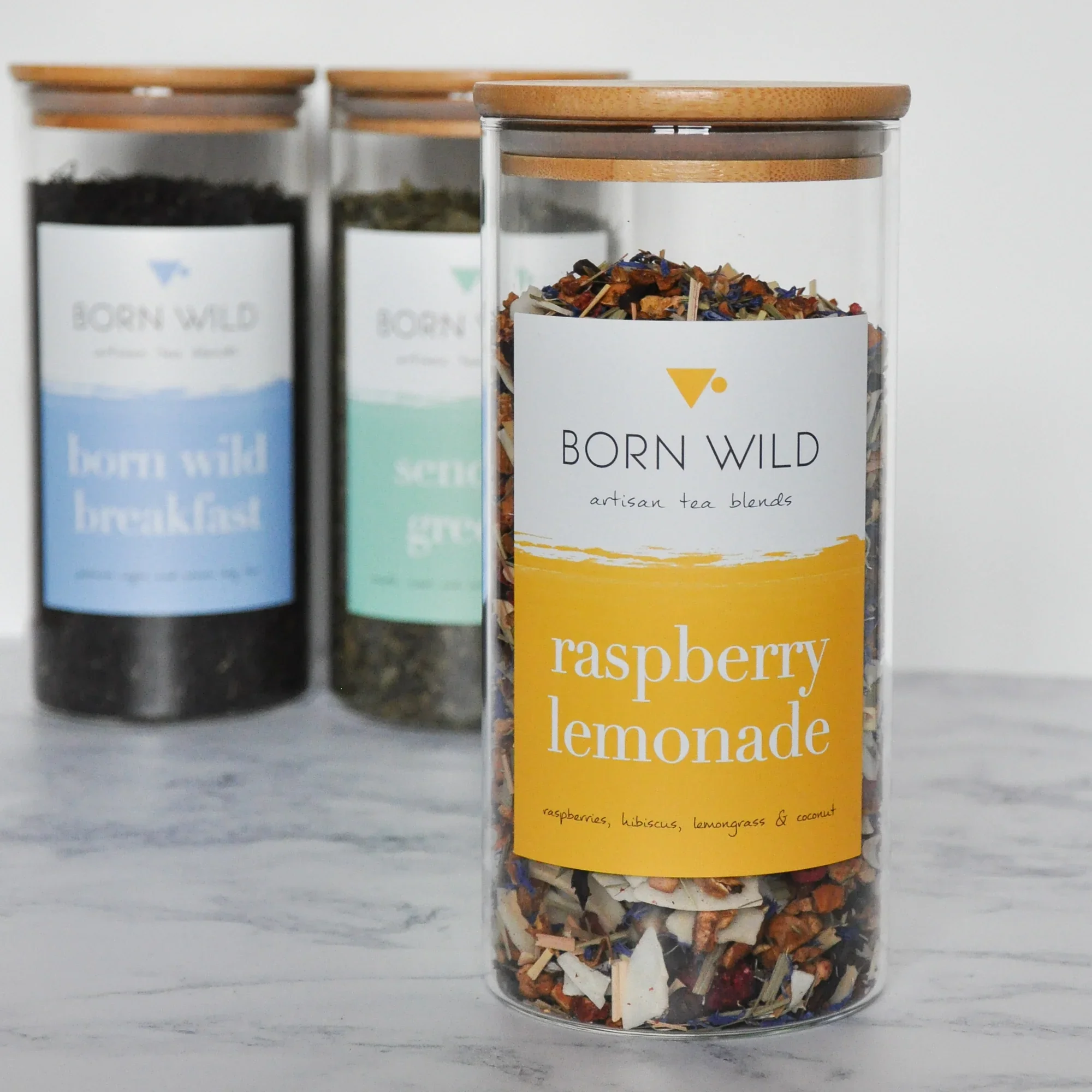 Born Wild loose-leaf teas in glass jars, with Raspberry Lemonade tea in the foreground.