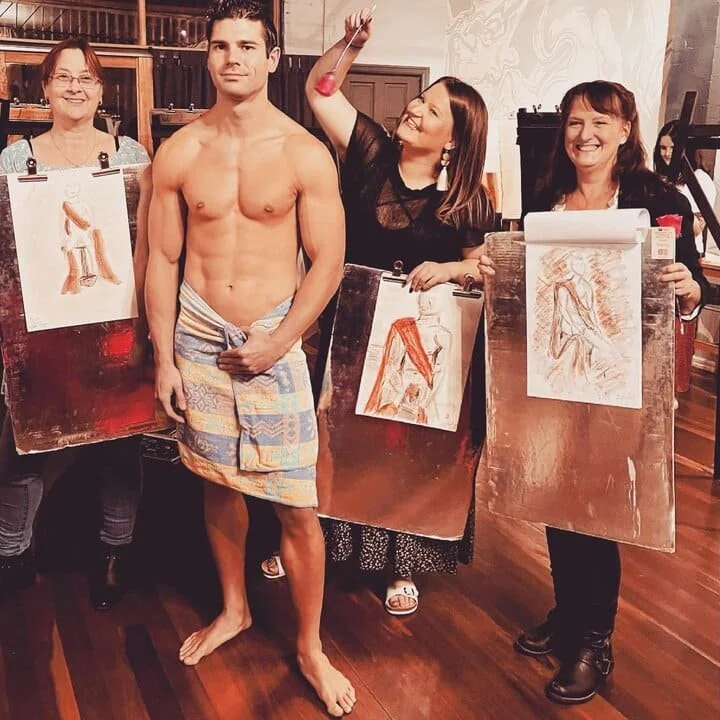 Male Paint and Sip with Females Holding Art.jpeg