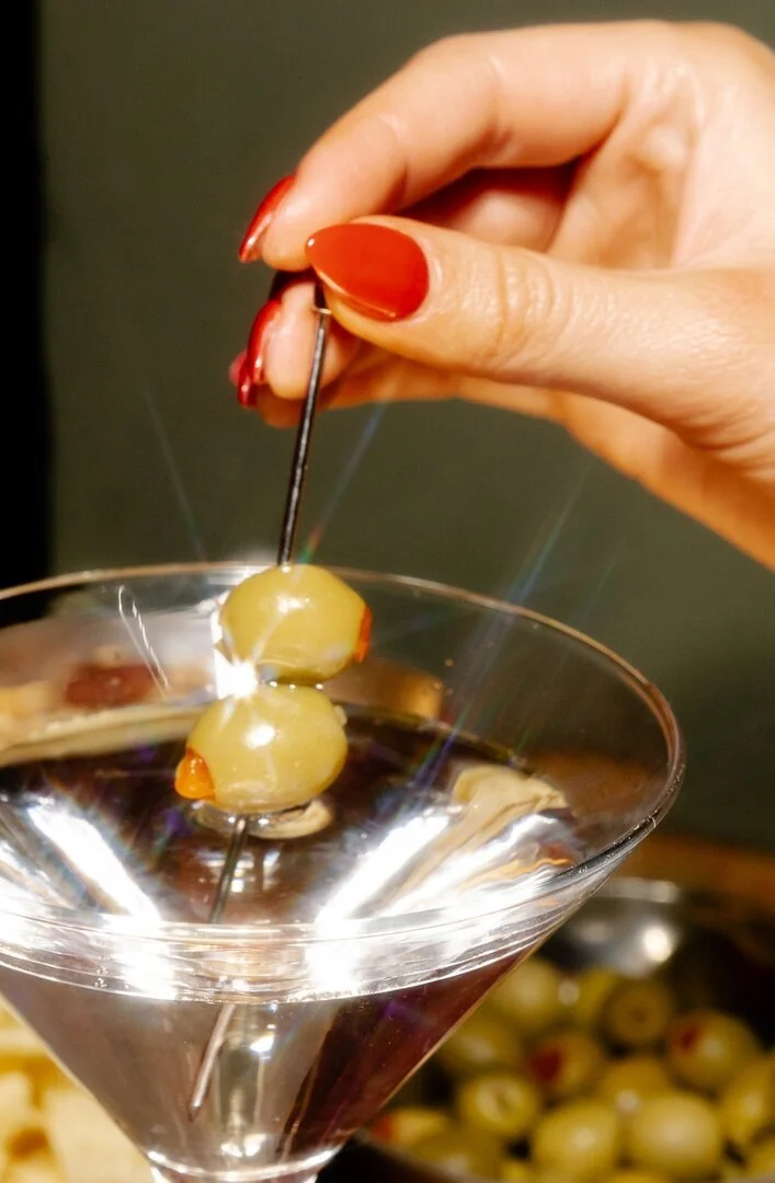 Dirty martini cocktail with olive on a pick in Melbourne served by VERTA events
