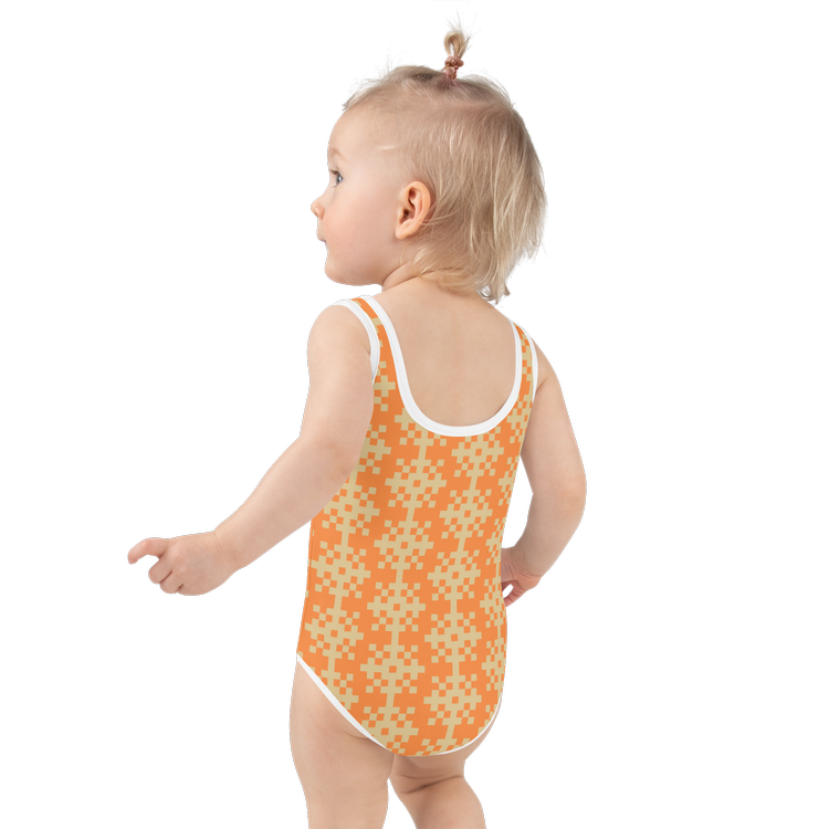 Toddler wearing an orange patterned swimsuit with a white trim. Kids fashionable swimwear in stylish custom design.