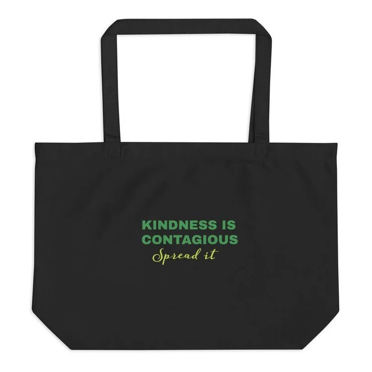 Black tote bag with custom print "Kindness is Contagious, Spread it" in green letters. Shopping with purpose and inspiring others.
