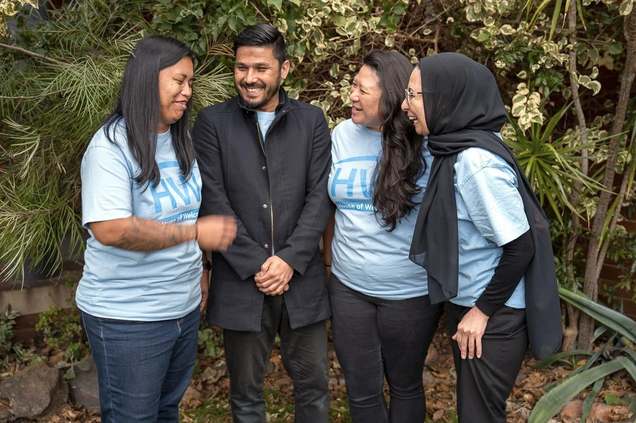 Marie, Sayed, Ruth and Hoorieh laughing in a group photo, representing what it is like to volunteer with House of Welcome