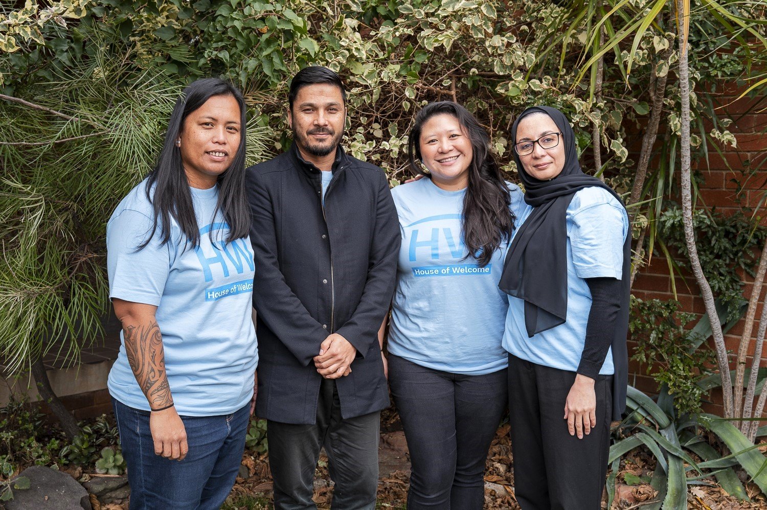 Image of Marie, Sayed, Ruth, and Hoorieh from House of Welcome, taking a group photo to represent the personalised casework they support