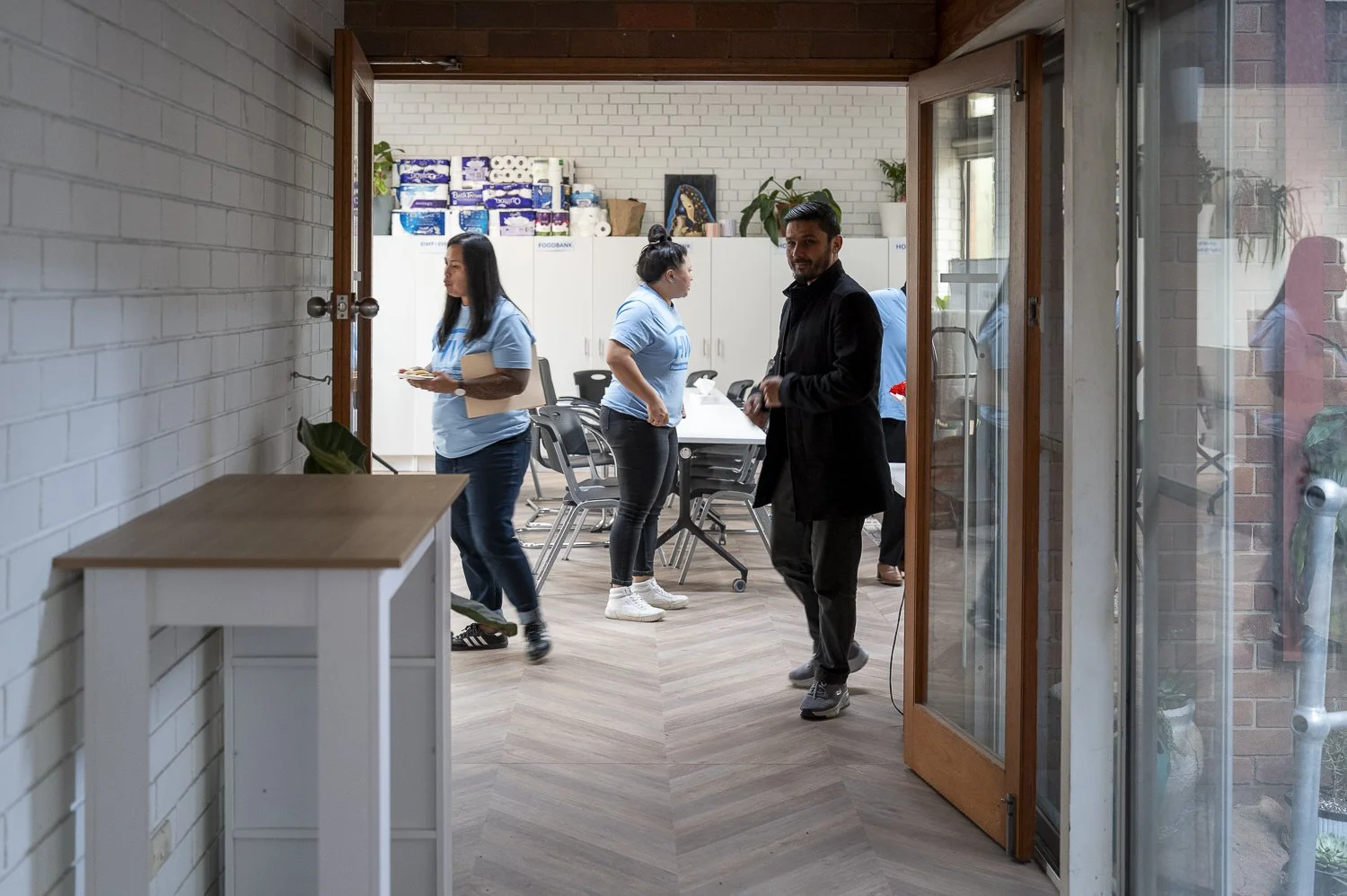 Marie, Ruth, Sayed and Hoorieh moving around the House of Welcome office