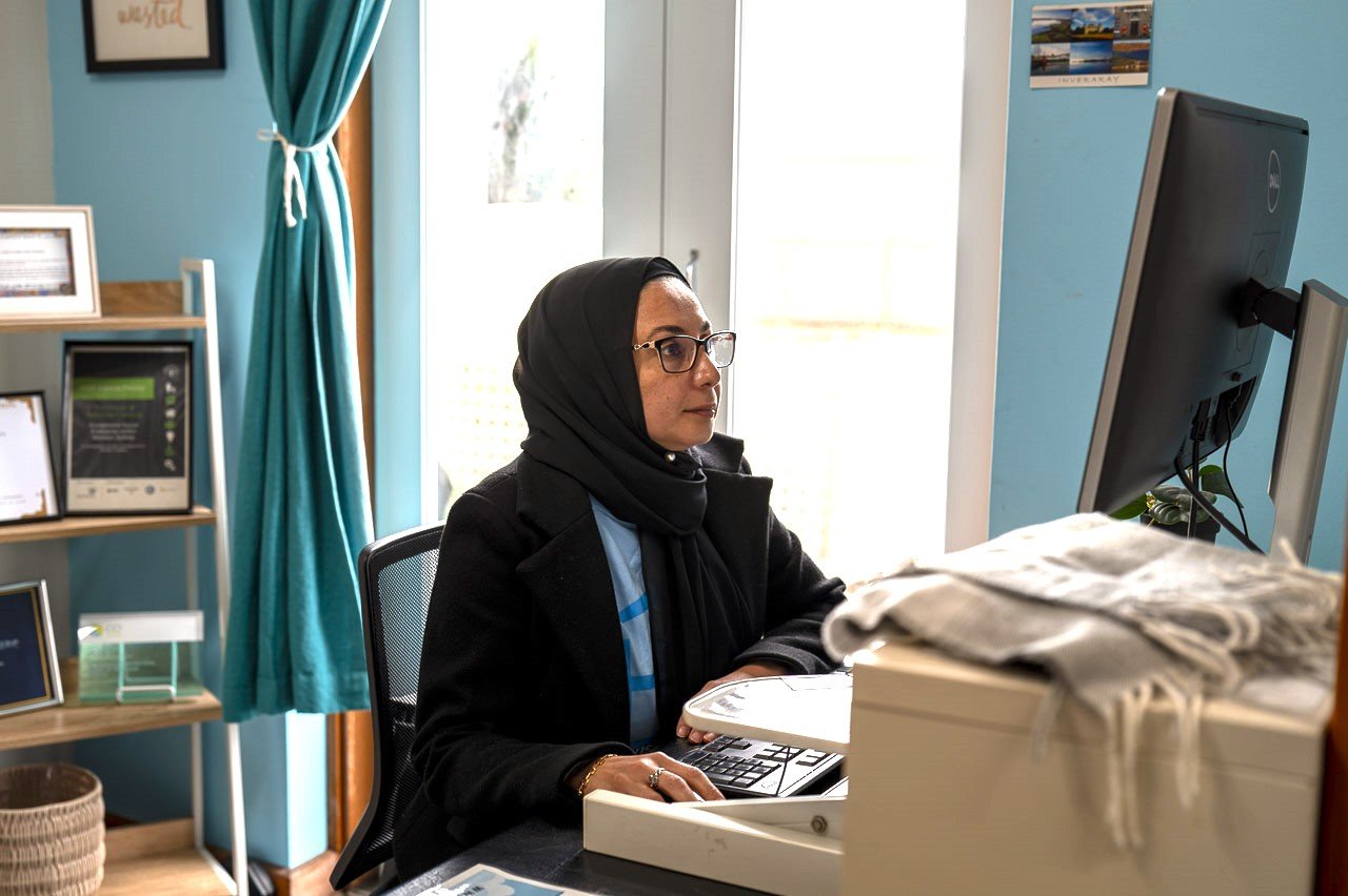 Hoorieh working on casework, representing how House of Welcome delivers wrap-around support in casework