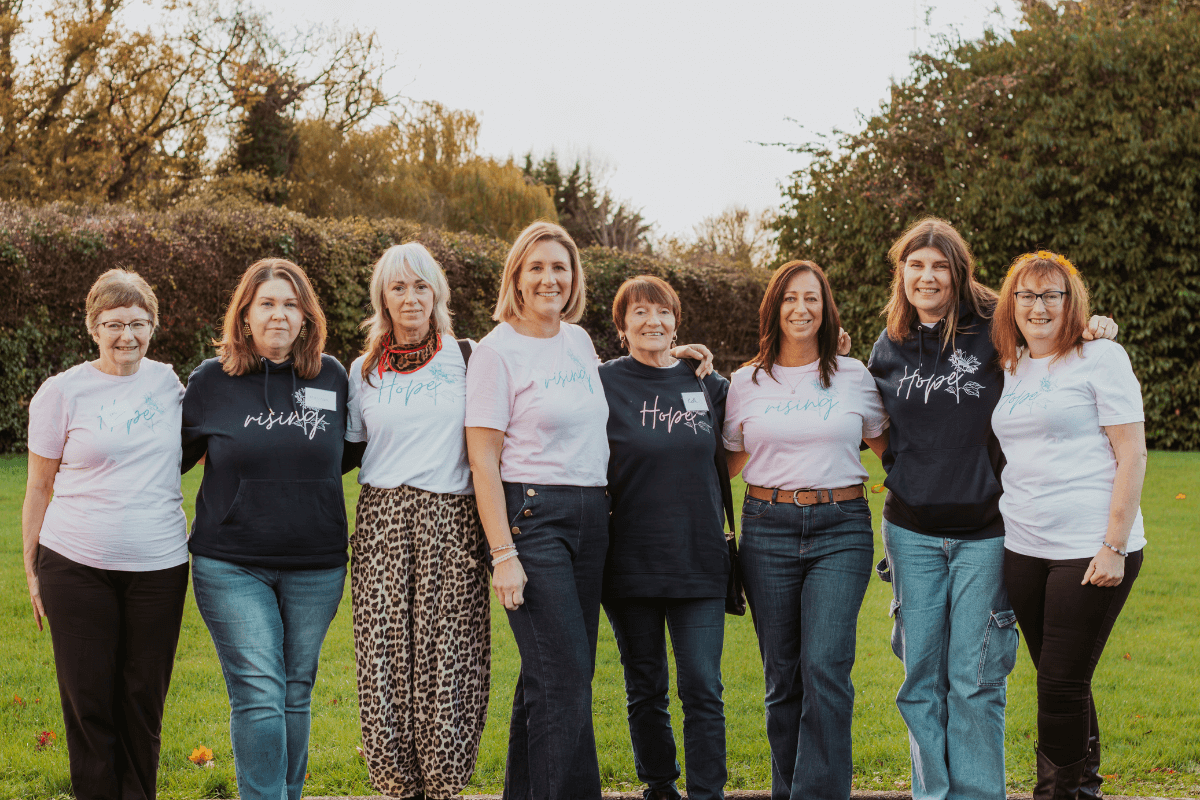 The retreat monitors standing together, representing the support, compassion, and care offered throughout the event