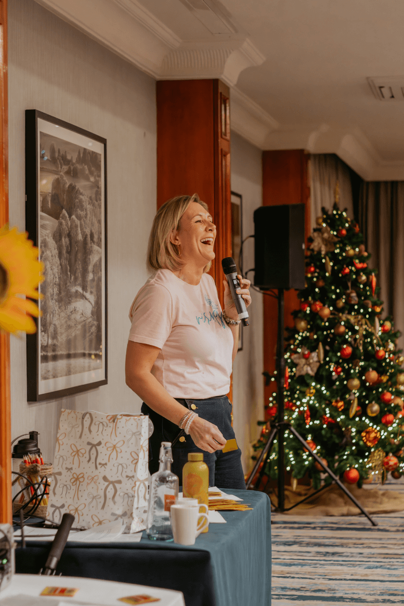 Karen Sutton speaking gently to widows during a Christmas retreat focused on comfort, healing, and encouragement