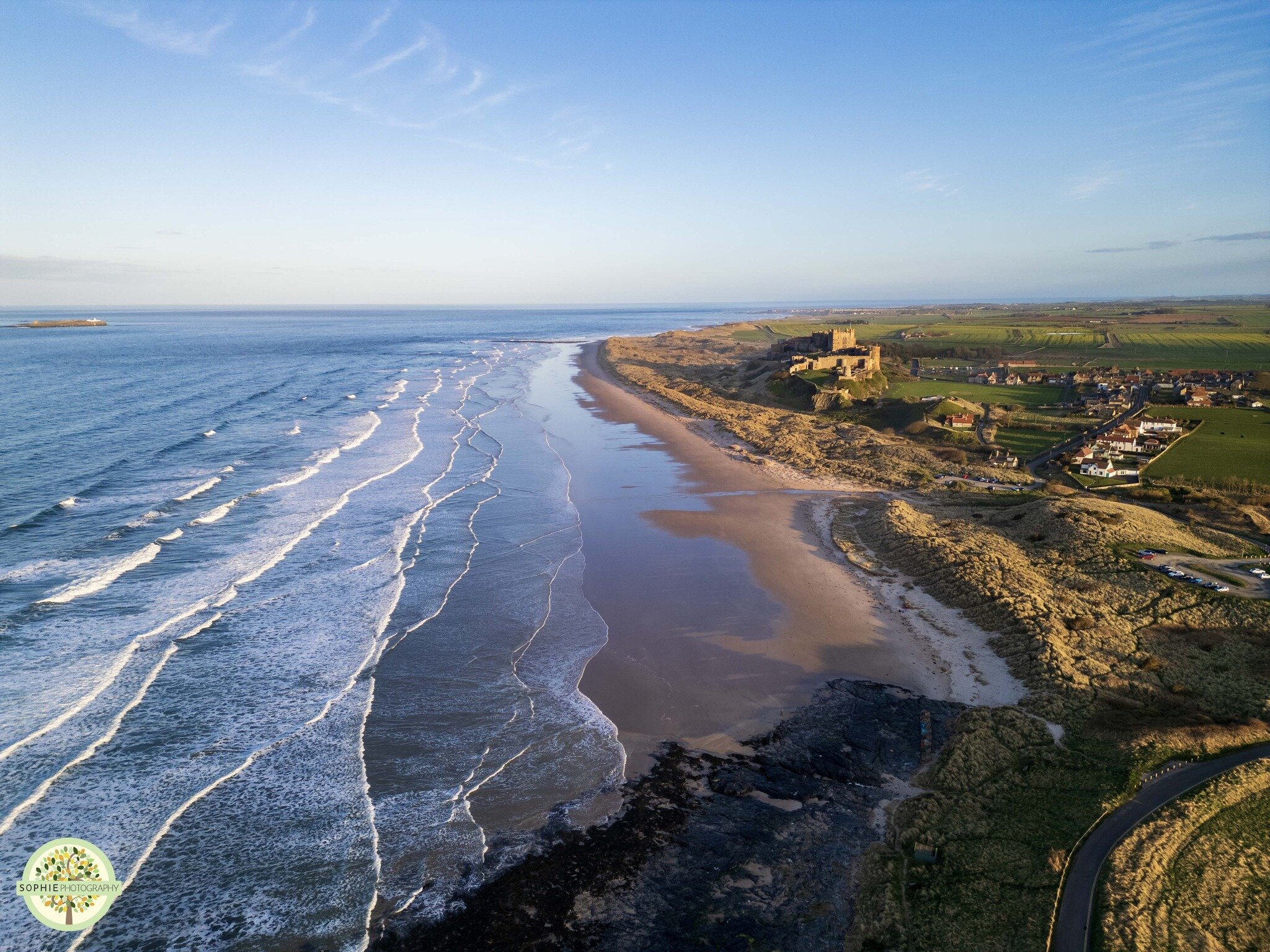 I just love sunny days at the beach! 🏖🌟

Bamburgh beach looks so spectacular from the sky, the shapes the waves create, the shiny wet sand, the dramatic rocks and of course the impressive castle - what more could you ask for?

 #sophiephotography #