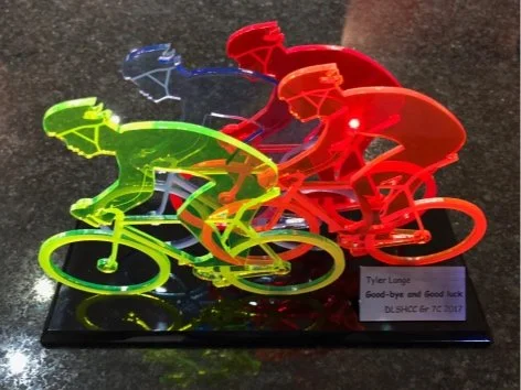 Neon-colored acrylic peleton bicycle trophy a black base.