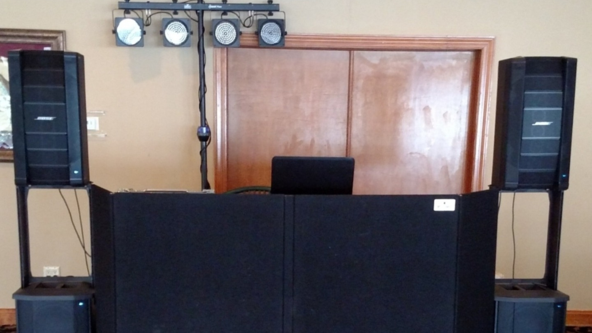 DJ booth setup with speakers and lighting