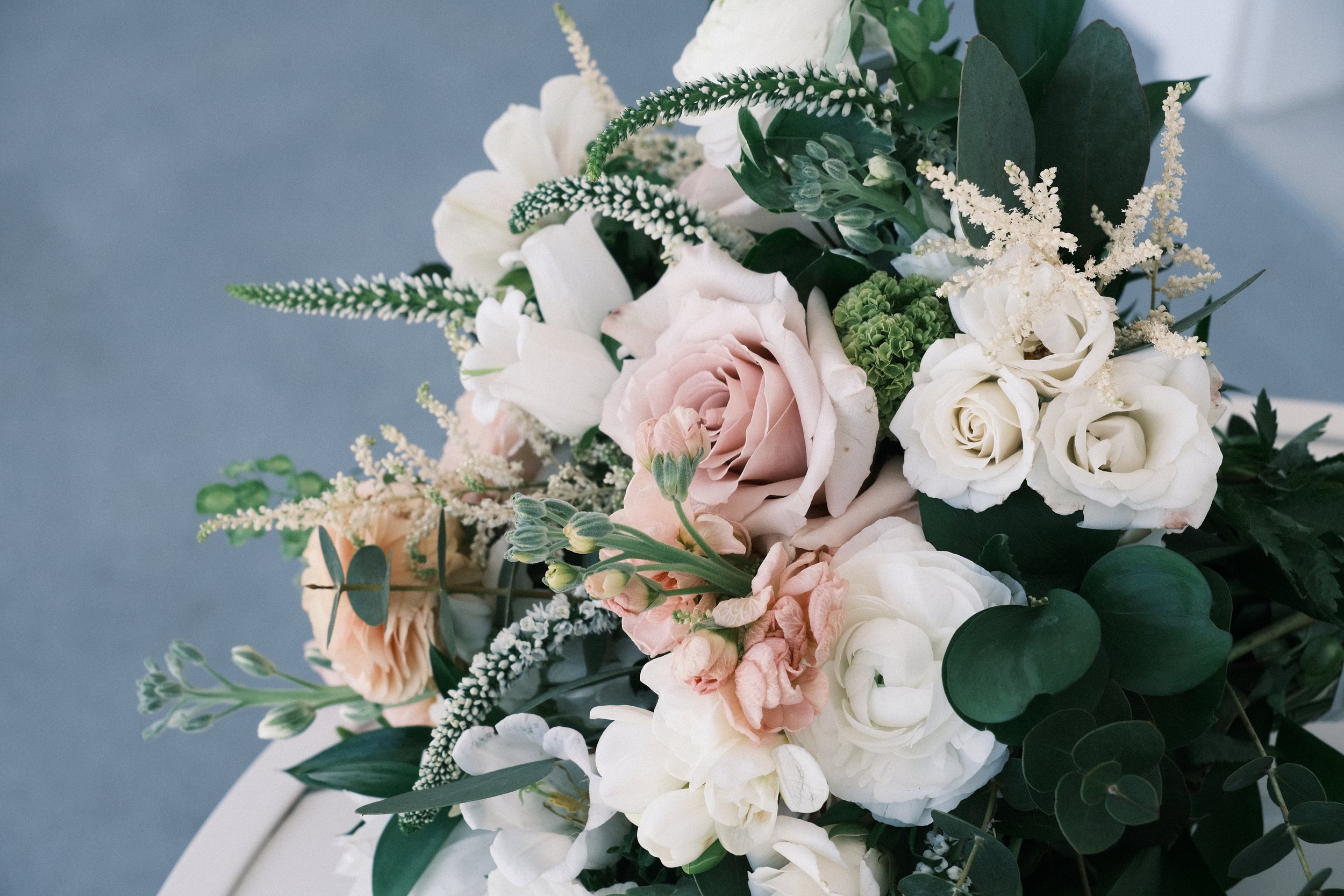 Bouquet of roses and various flowers with greenery