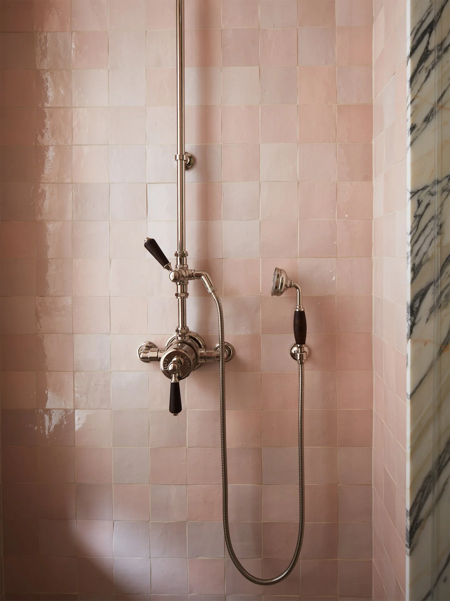 Closeup of pink shower tiles.