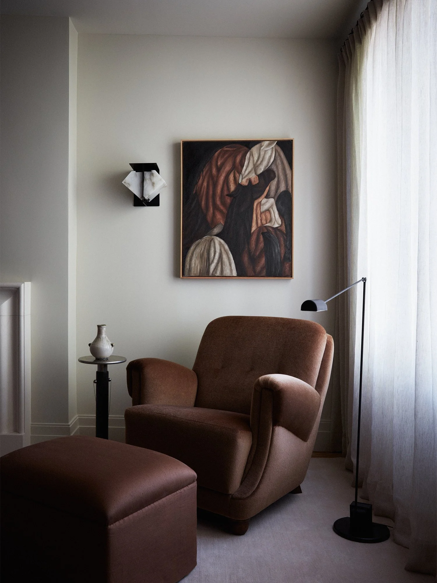 Lounge chair and ottoman in bedroom.