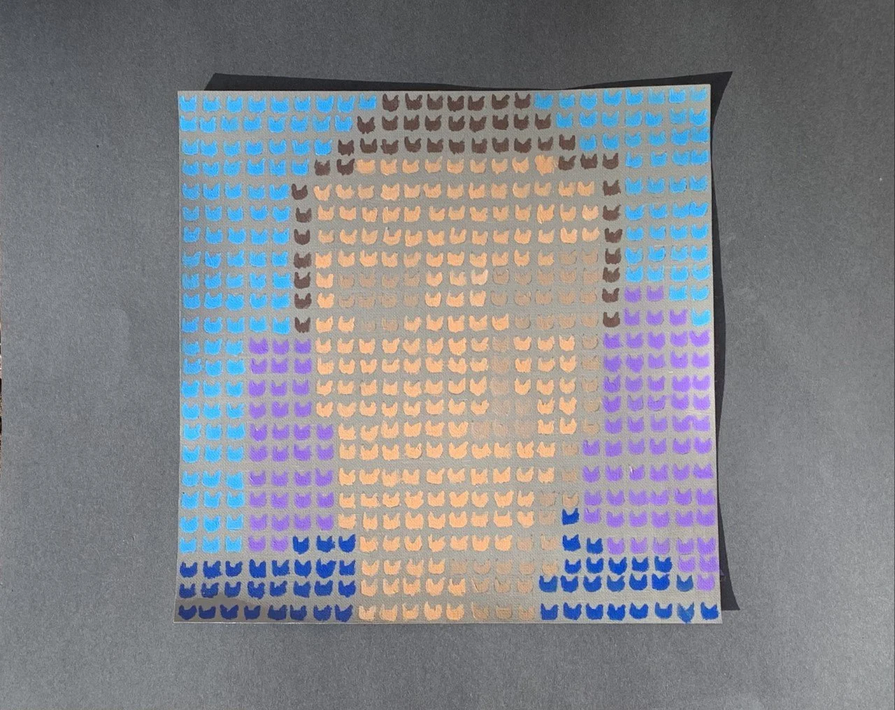 This was a painting where I had to make a portrait of myself through a filter and recreate it by using one particular shape over and over again. I made a small cat head to duplicate over and over again.