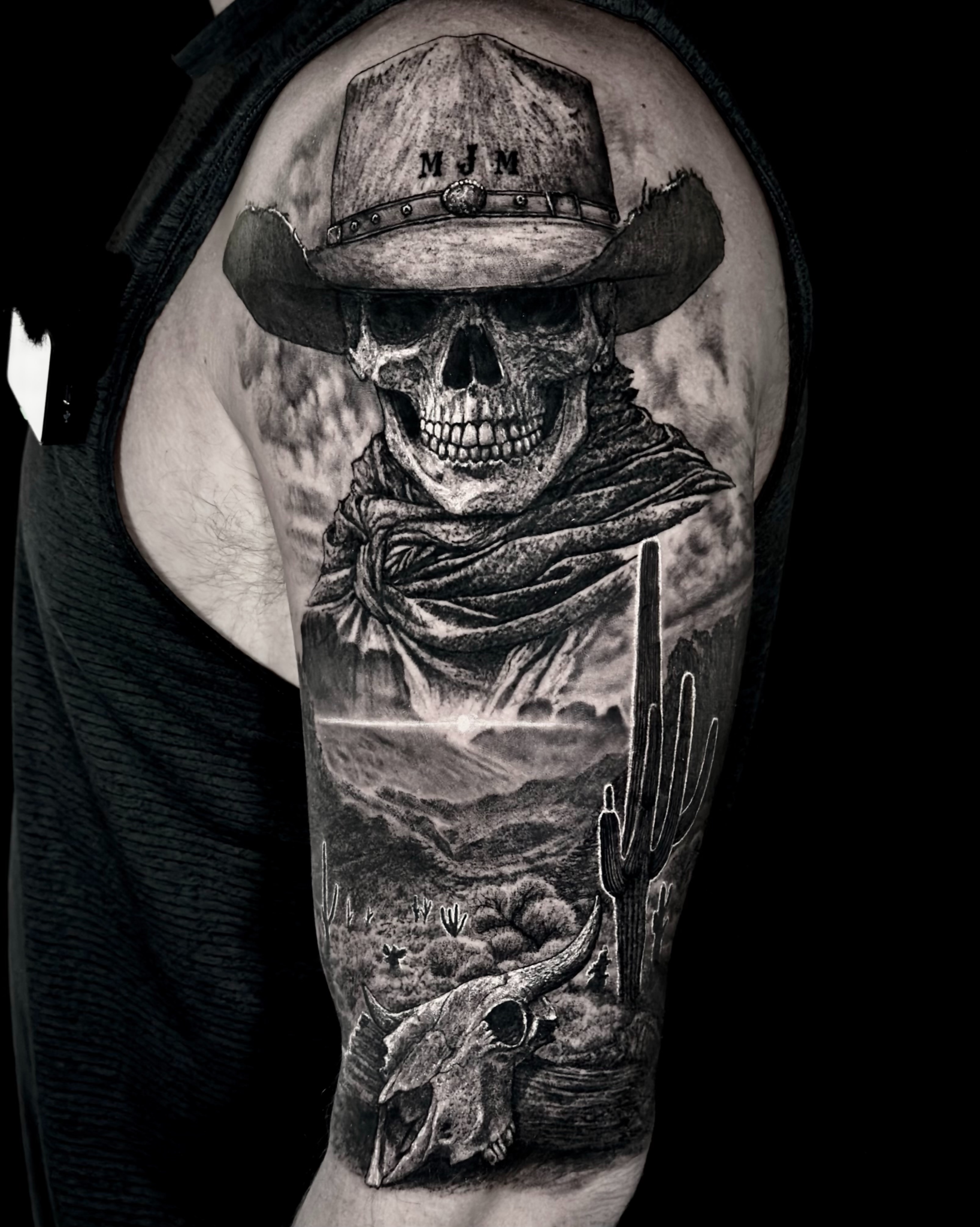 Skeleton cowboy in the desert realism tattoo on the upper arm by Etgar Oak