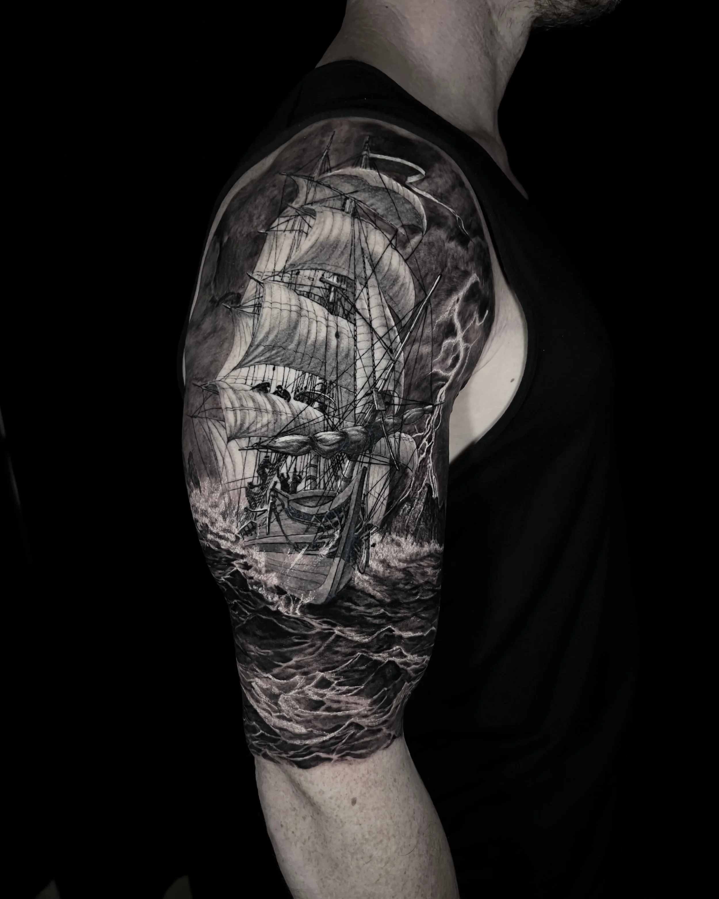 Sailing ship in a storm realism tattoo on the upper arm by Etgar Oak