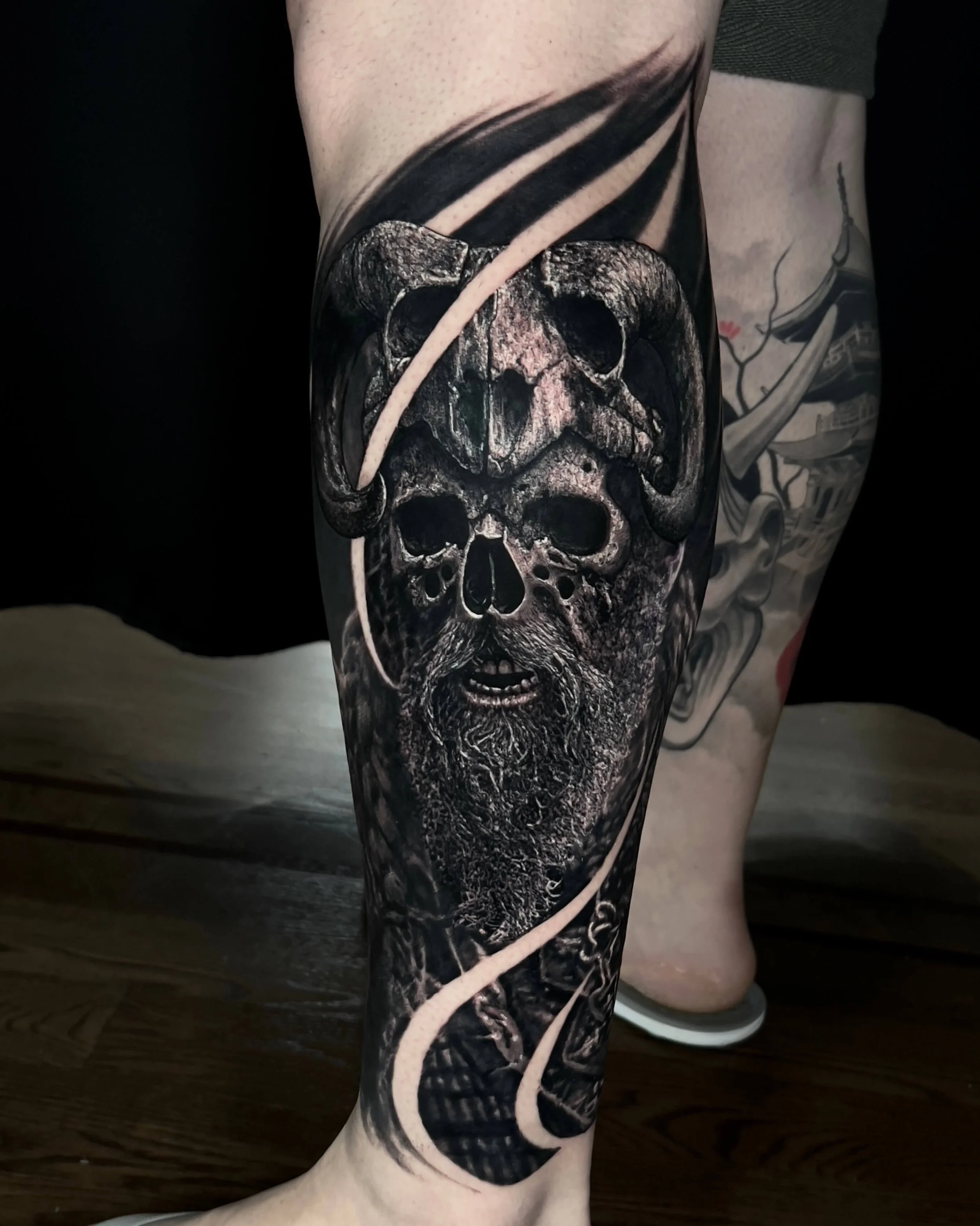 Viking skull with horned helmet realism tattoo on the calf by Etgar Oak