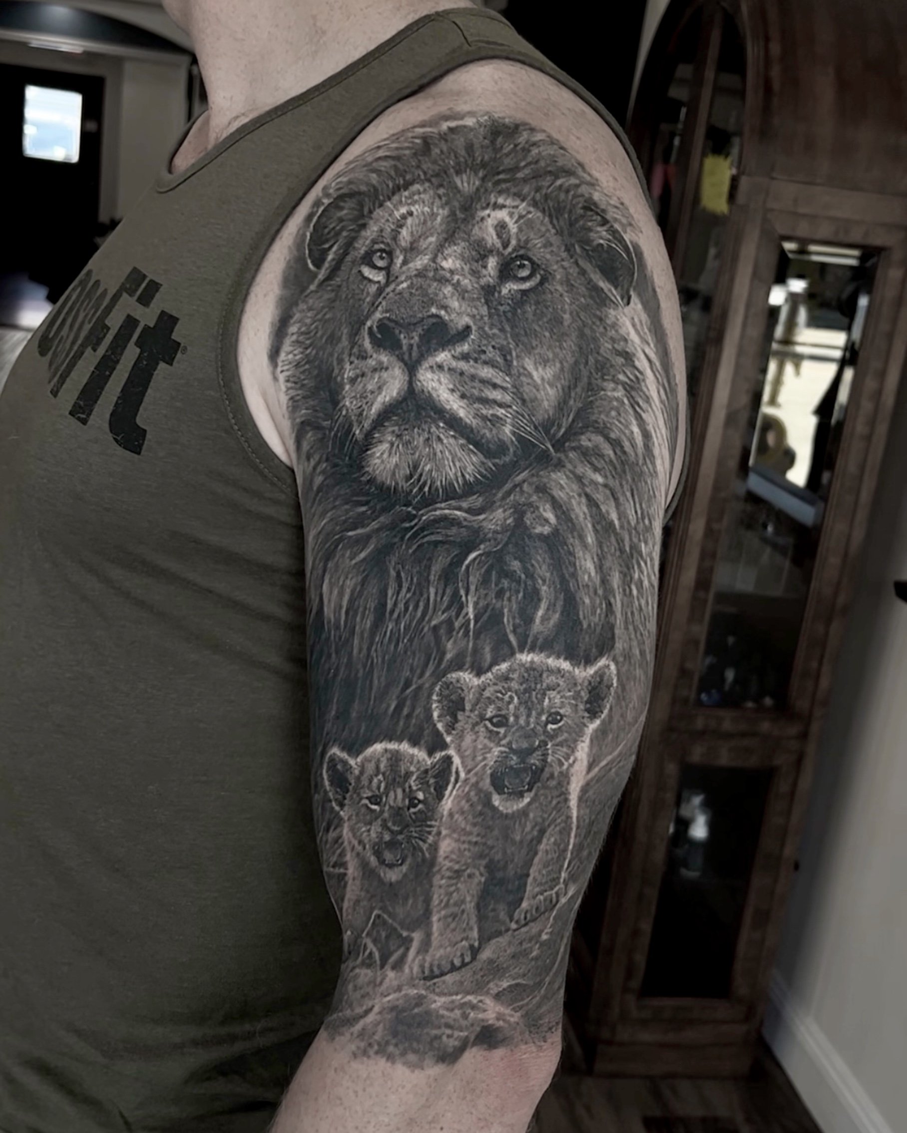 Healed lion and cubs realism tattoo on the upper arm by Etgar Oak