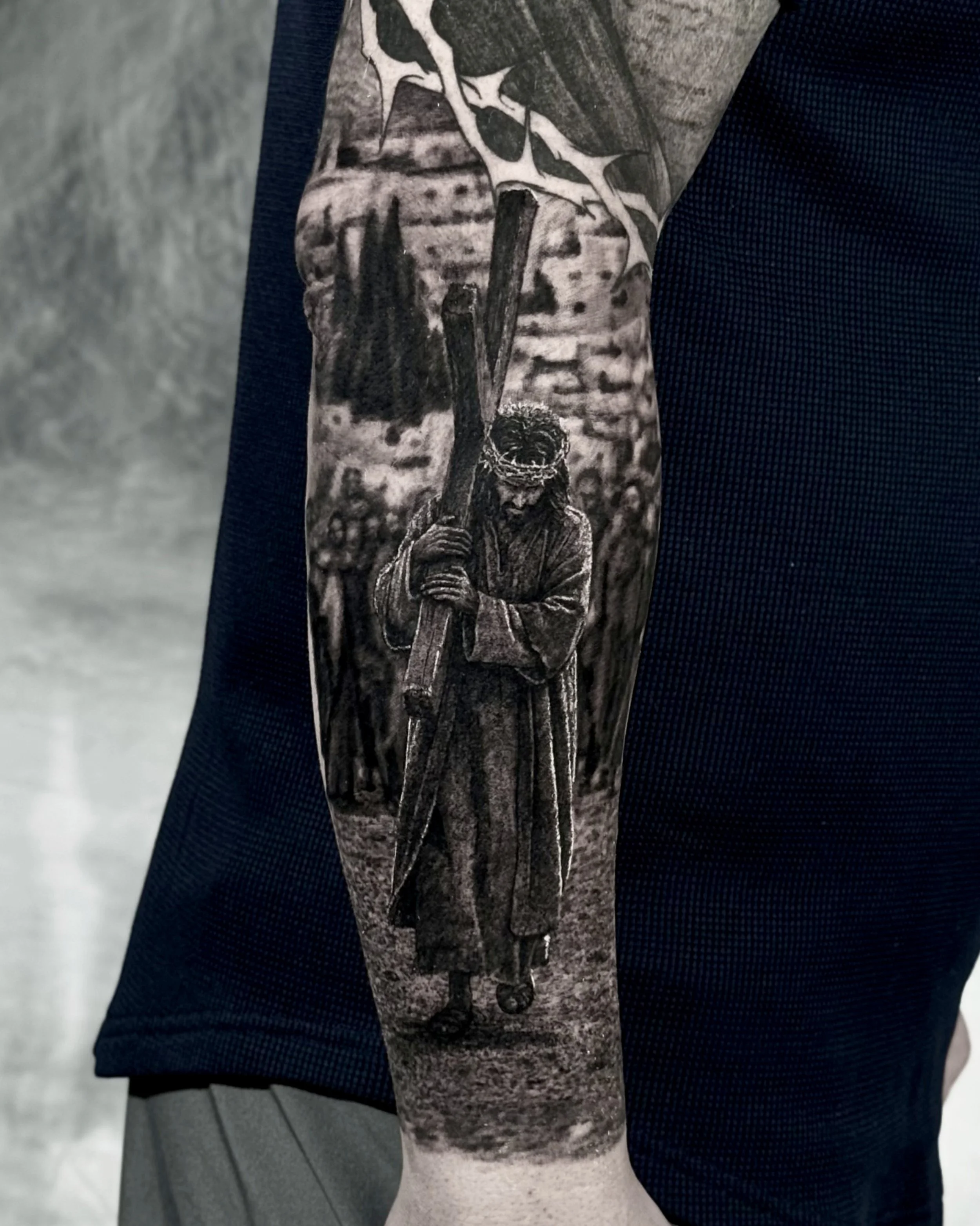 Jesus carrying the cross realism tattoo on the forearm by Etgar Oak
