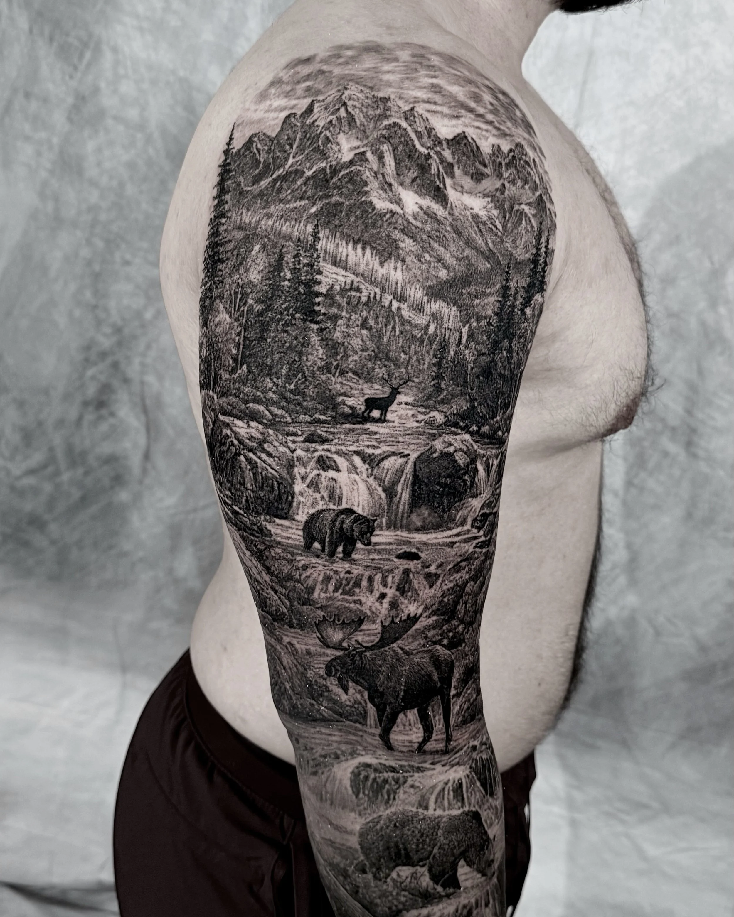 Mountain wildlife full arm sleeve realism tattoo by Etgar Oak