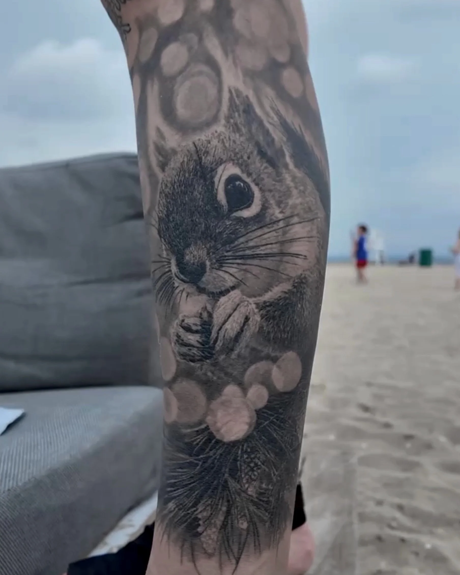 Healed squirrel with bokeh lights realism tattoo by Etgar Oak