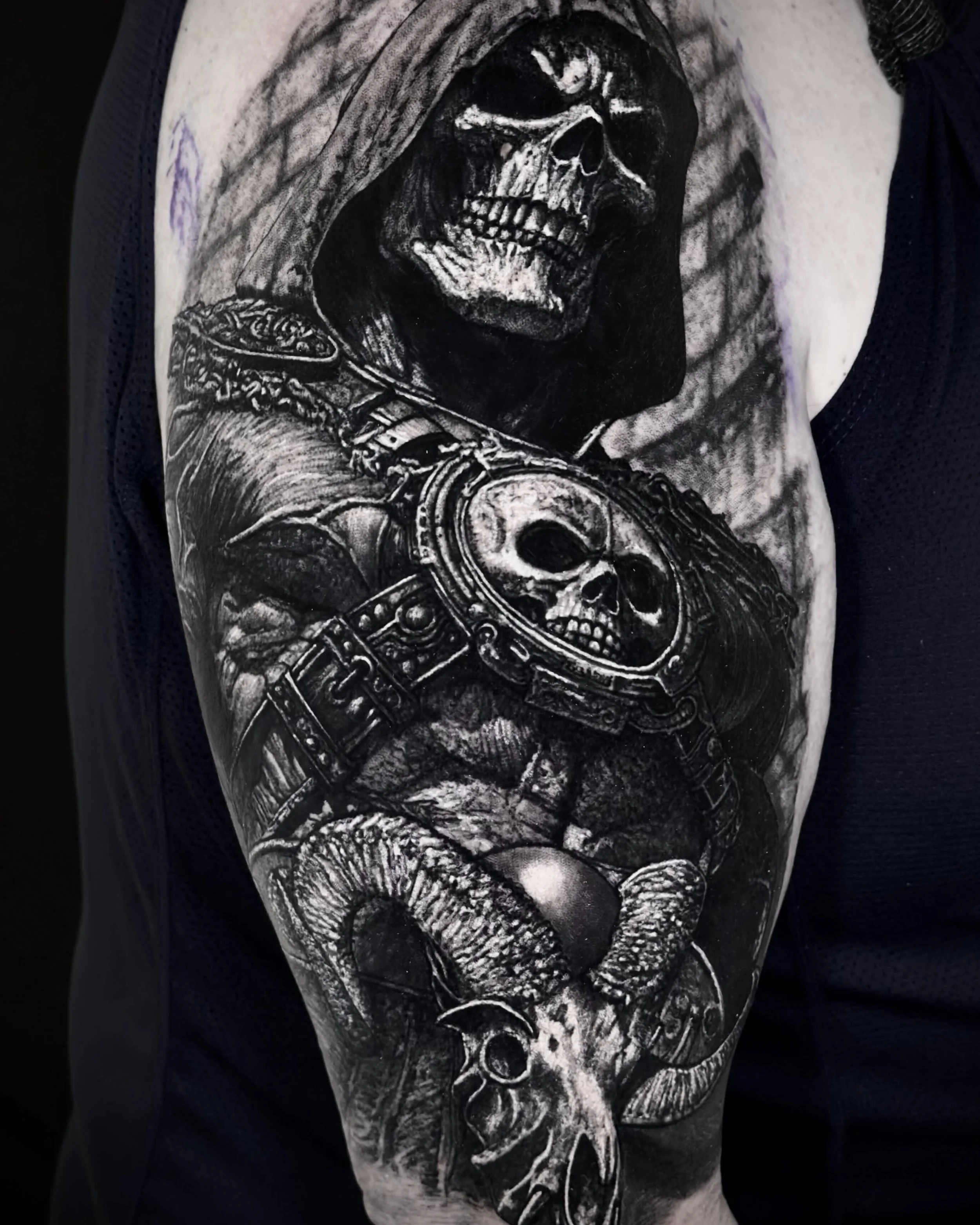 Hooded skull warrior realism tattoo on the upper arm by Etgar Oak