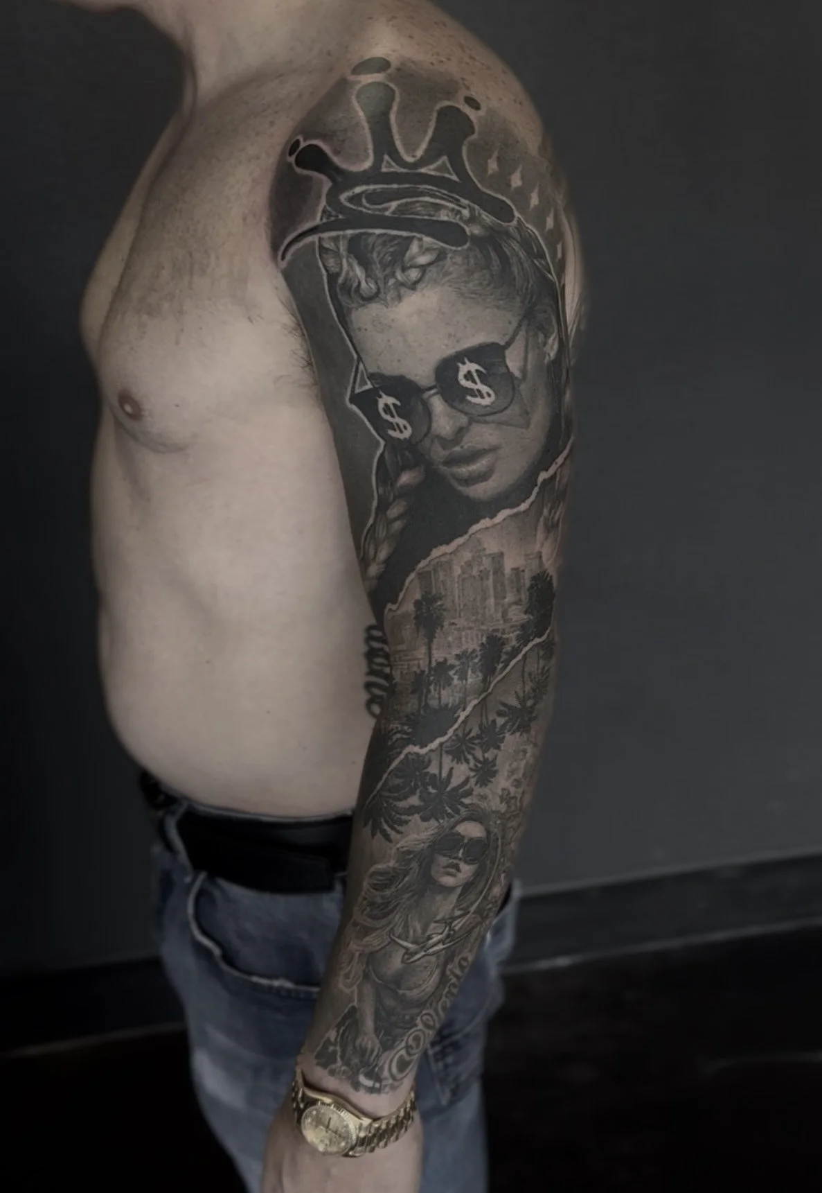 Healed woman in dollar-sign sunglasses with crown, full sleeve realism tattoo by Etgar Oak