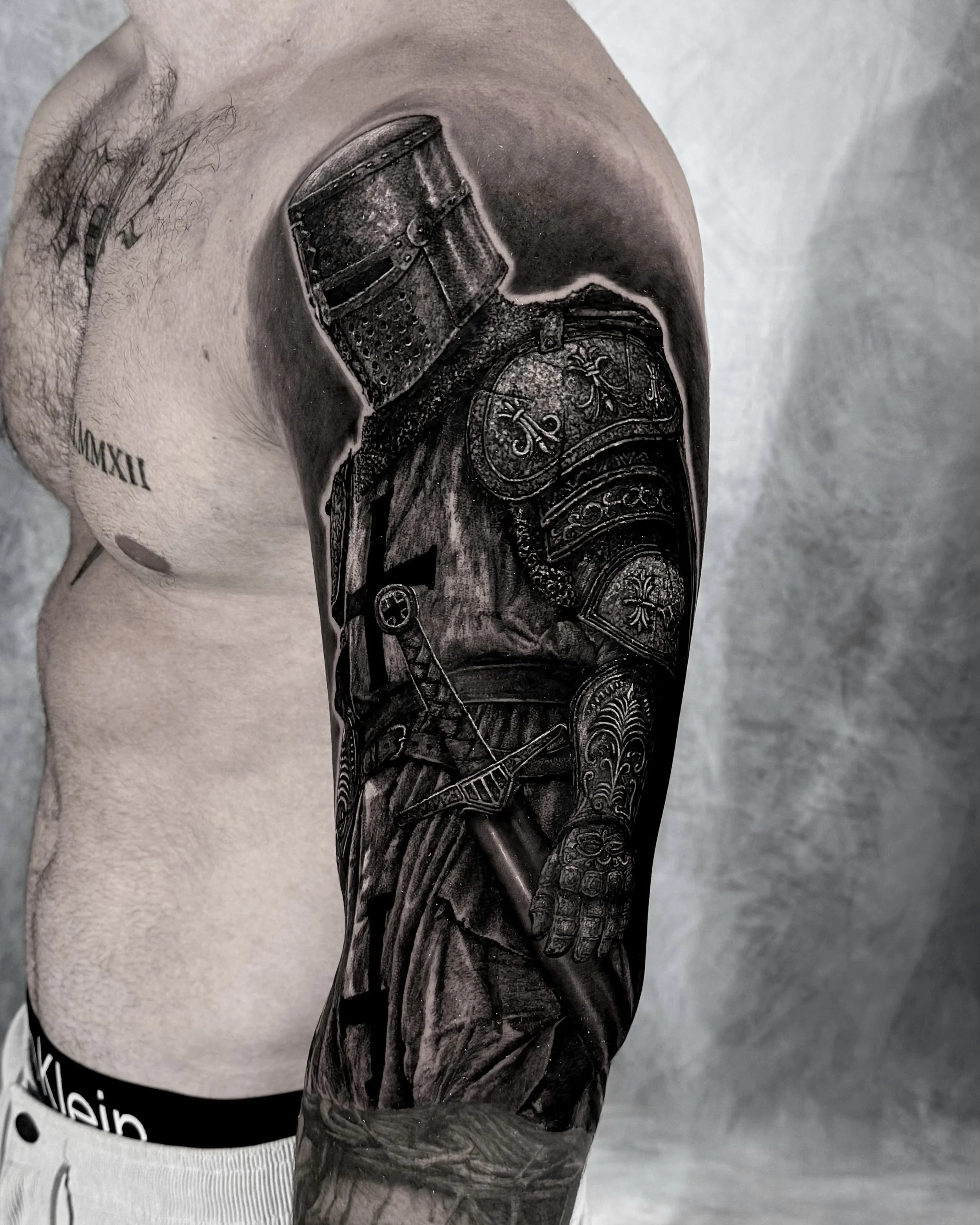 Crusader knight realism tattoo on the upper arm by Etgar Oak