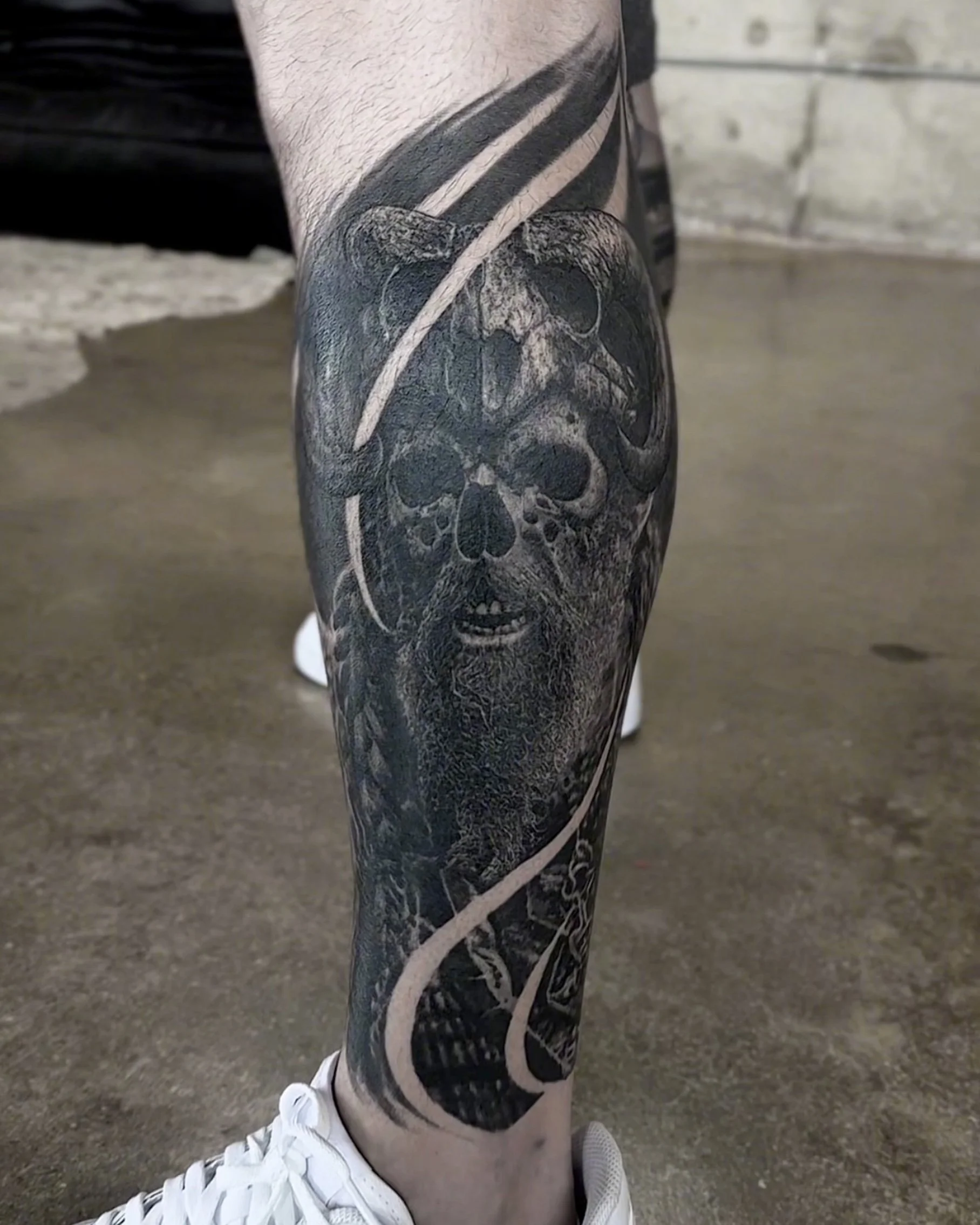 Healed viking skull with horned helmet realism tattoo on the calf by Etgar Oak