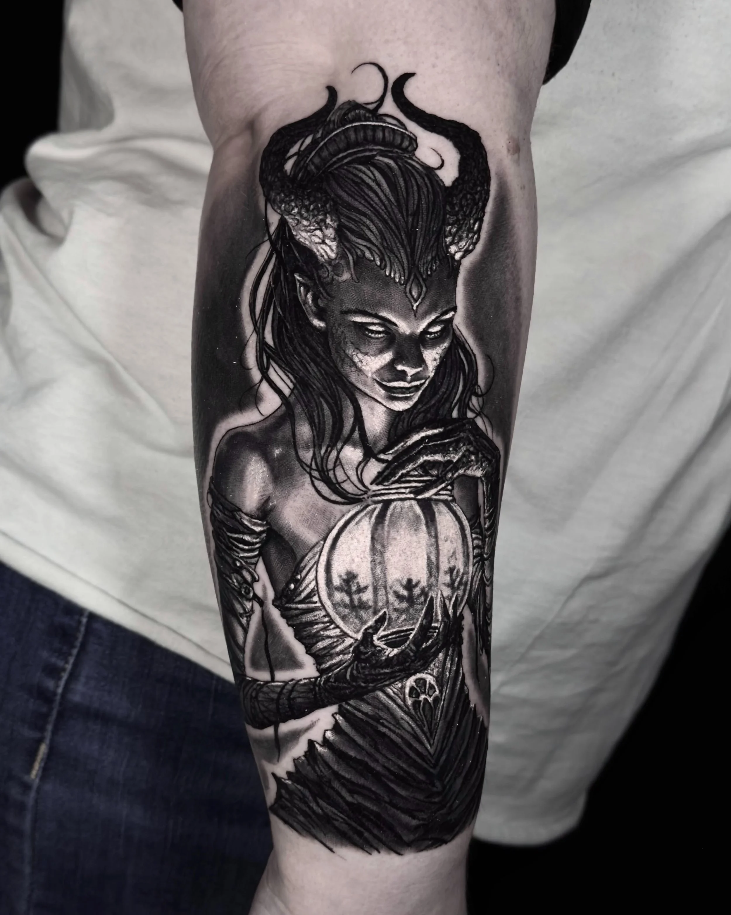 Horned demon woman with lantern realism tattoo on the forearm by Etgar Oak