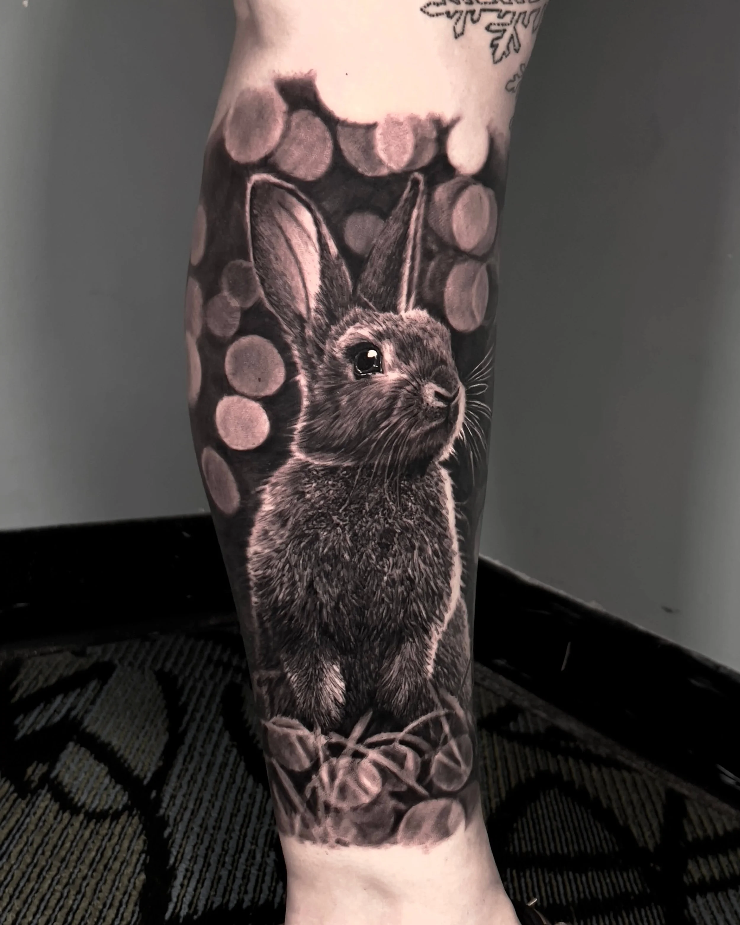 Rabbit with bokeh lights realism tattoo by Etgar Oak
