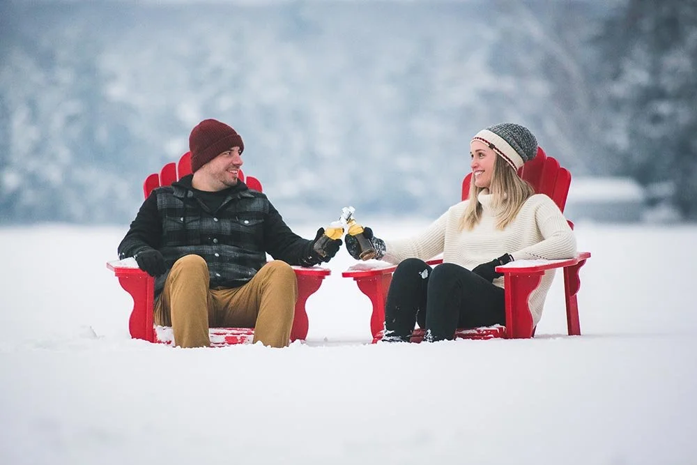 Couple in muskoka chairs in winter