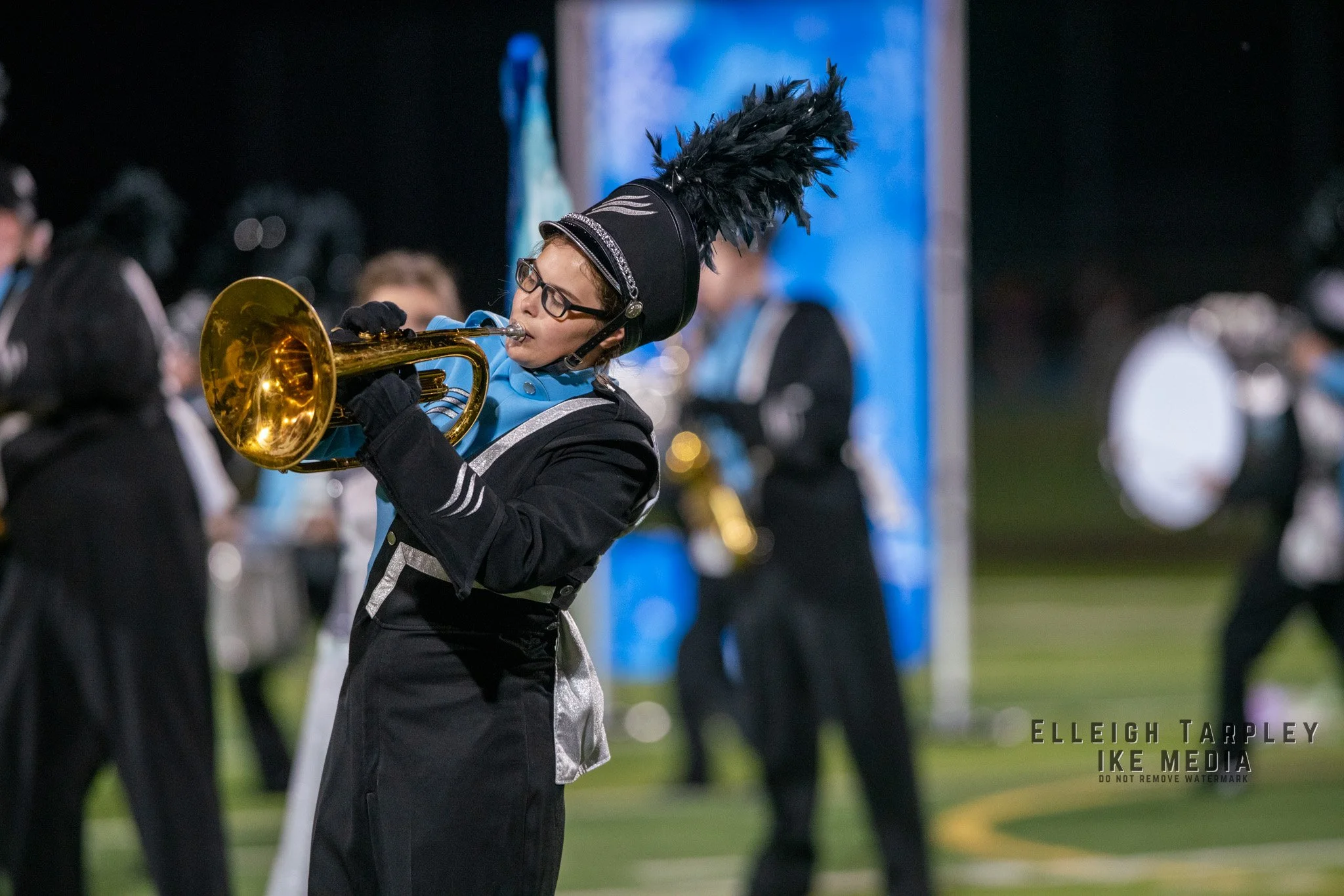 A trumpet player gives Eisenhower fans a sneak peak into their competition movement during the halftime game against Newton on Sept. 19.
