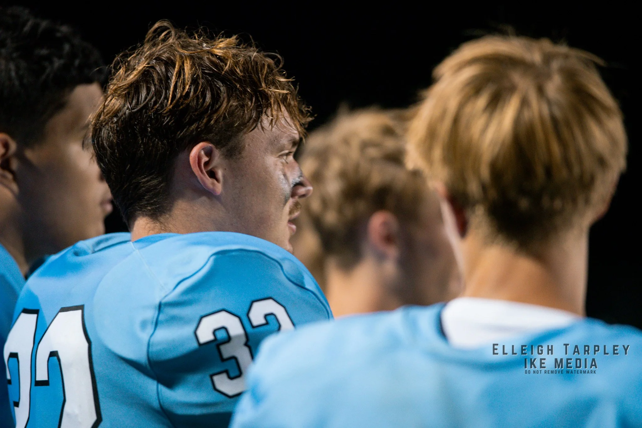 Senior Jameson Turner talks over plays with sophomore Braeden Schulte. Coach Darin Fisher reviewed plays in the locker room during halftime.