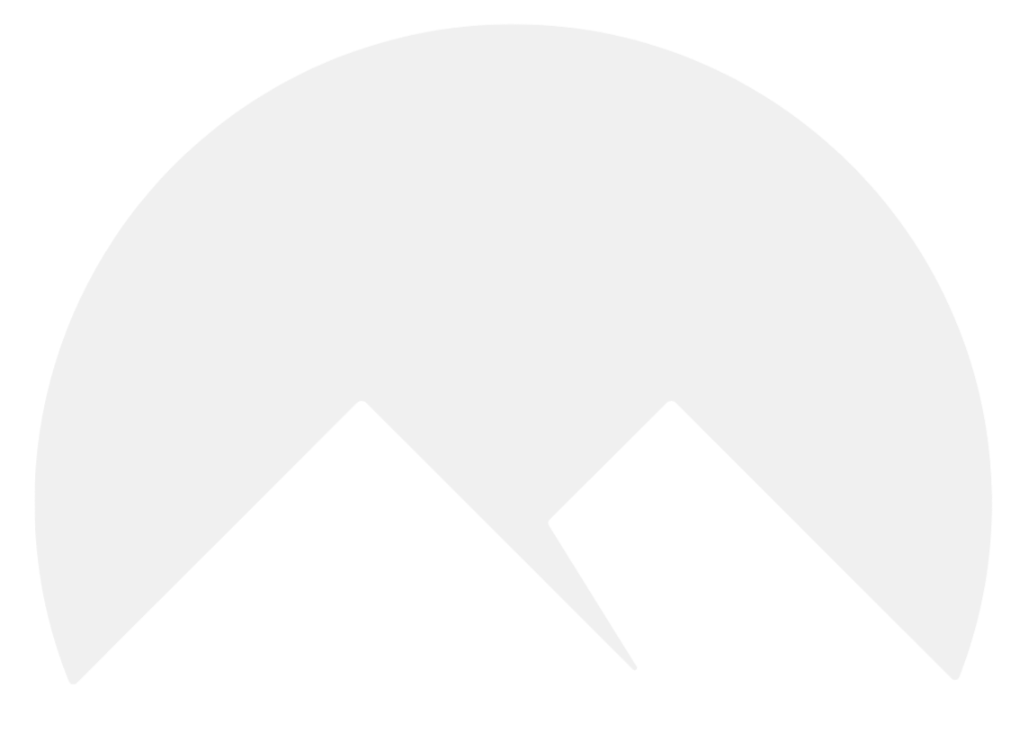 Black mountain peaks against a white sky.