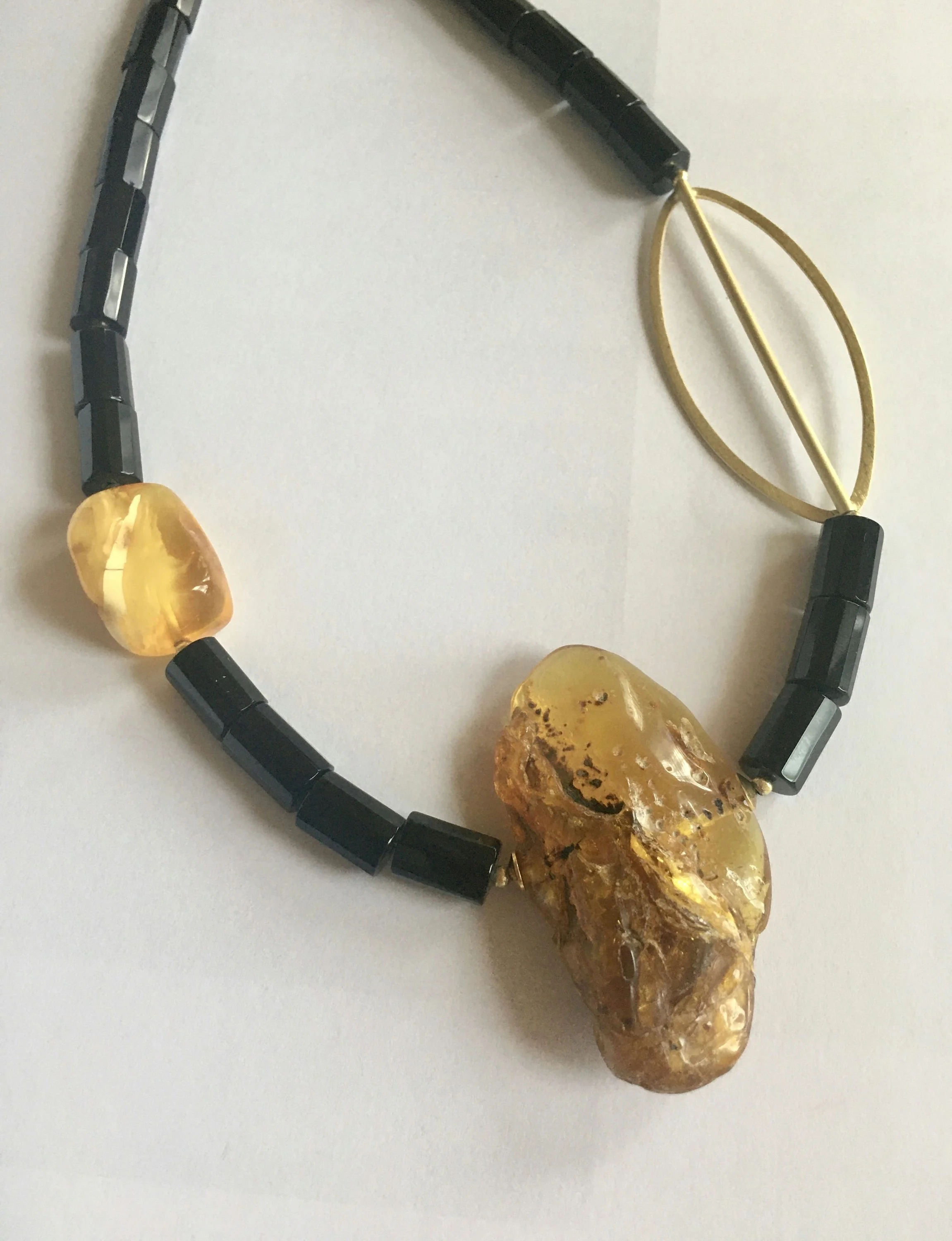 Ania Davis  I design jewelry out of passion for natural beauty of Baltic amber. All amber gems are hand polished and accompanied by subtle presence of sterling silver, 18k and 22k gold over silver, and other natural/organic stones.  I aim to create n