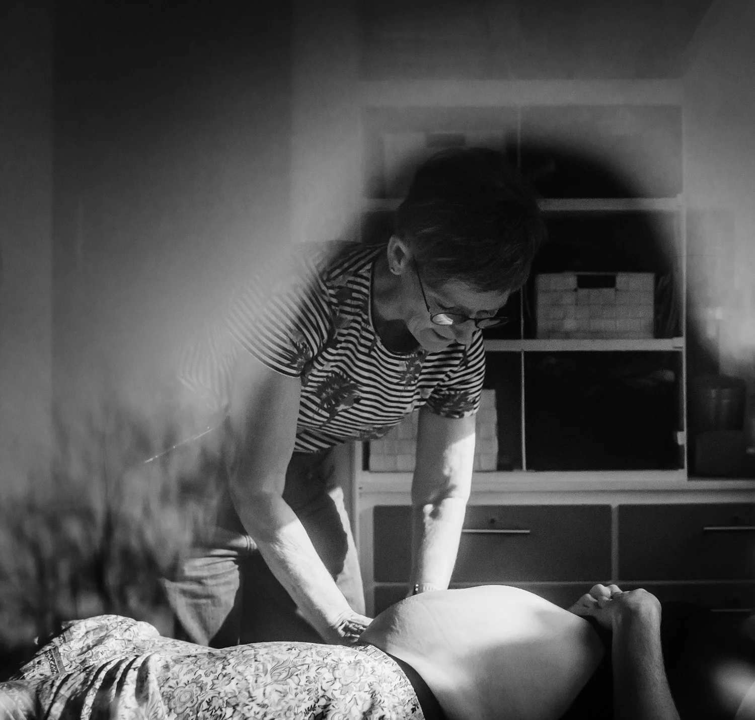 Georgina performing an antenatal examination on a pregnant woman at home