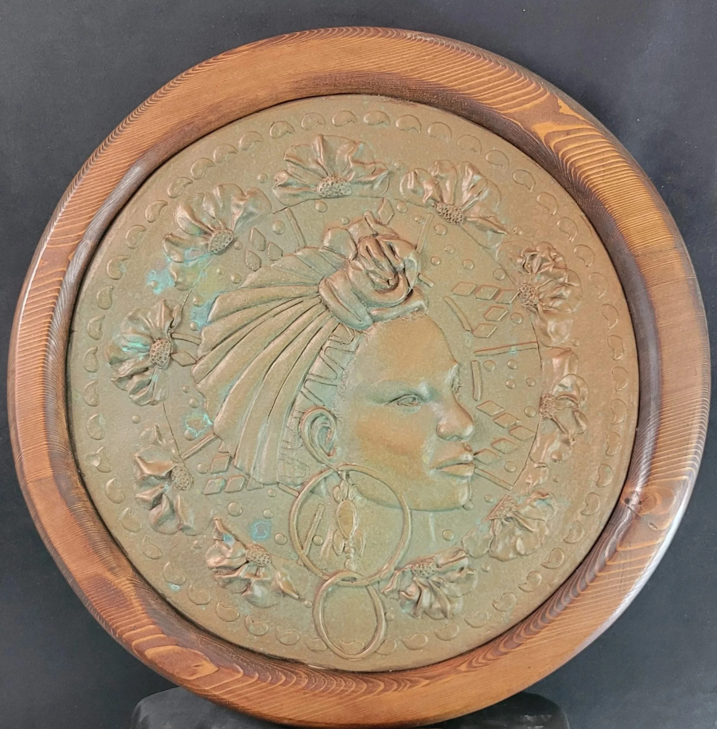 Grace in Heritage relief sculpture by Sharon Cruson, angled view emphasizing raised portrait details