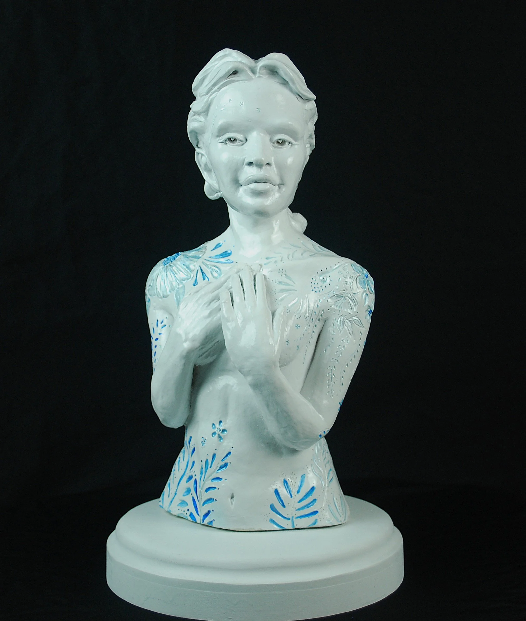 Cover Me in Springtime ceramic sculpture by Sharon Cruson, female bust with blue floral details on a white ceramic surface